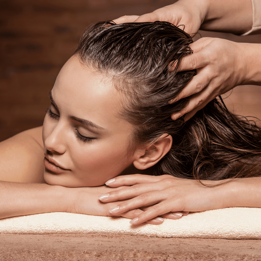 Woman receiving a relaxing head massage at a spa.