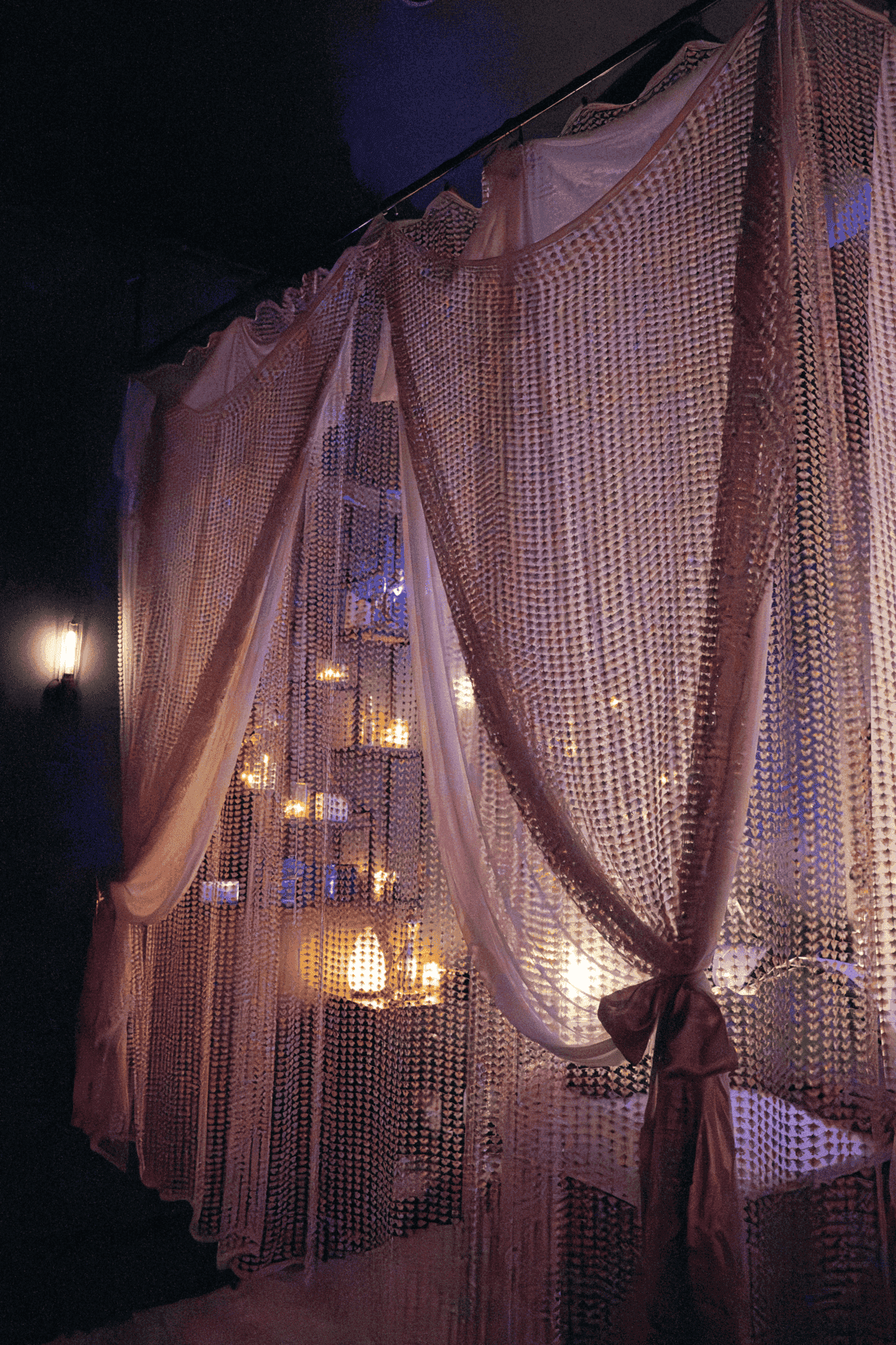 Elegant room with sheer curtains and dimly lit candles, creating a cozy ambiance.